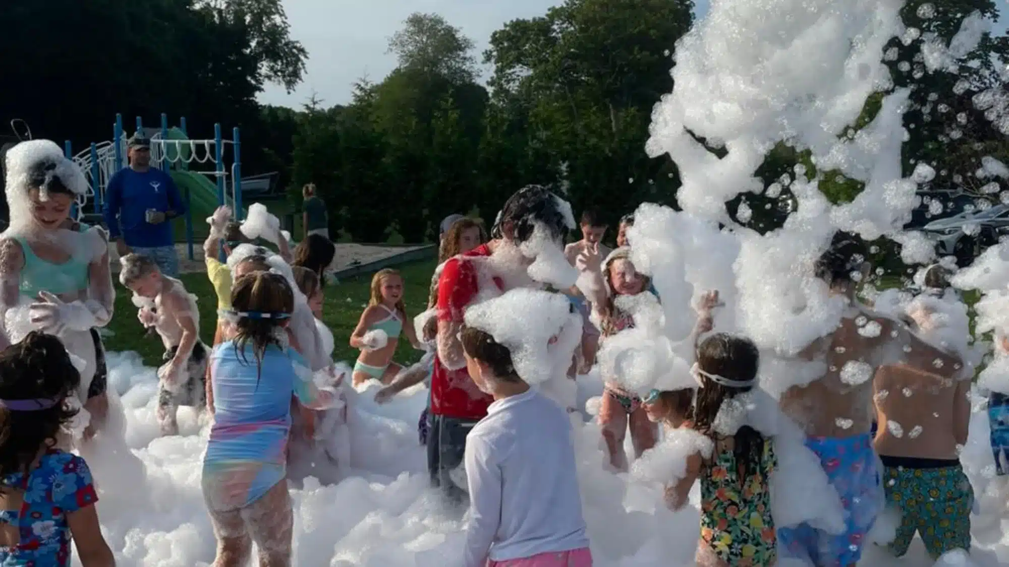 Foam party event in Babylon New York with full-service setup including foam machine operator and guests enjoying outdoor celebration