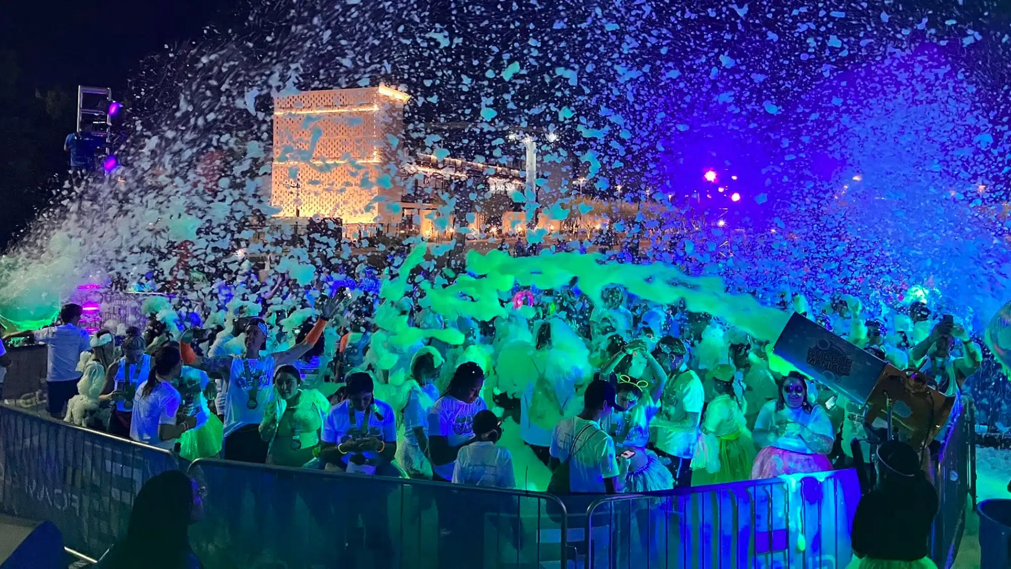 Outdoor foam party rental event in New York with foam machine creating large foam area for kids and guests during celebration