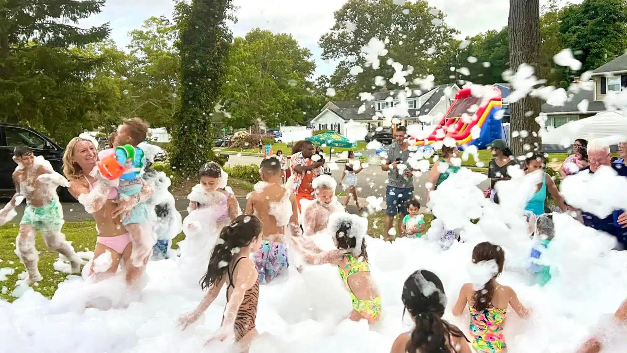 Foam party rental setup in Brookhaven New York with foam machine creating foam-filled play area for guests at a private outdoor event