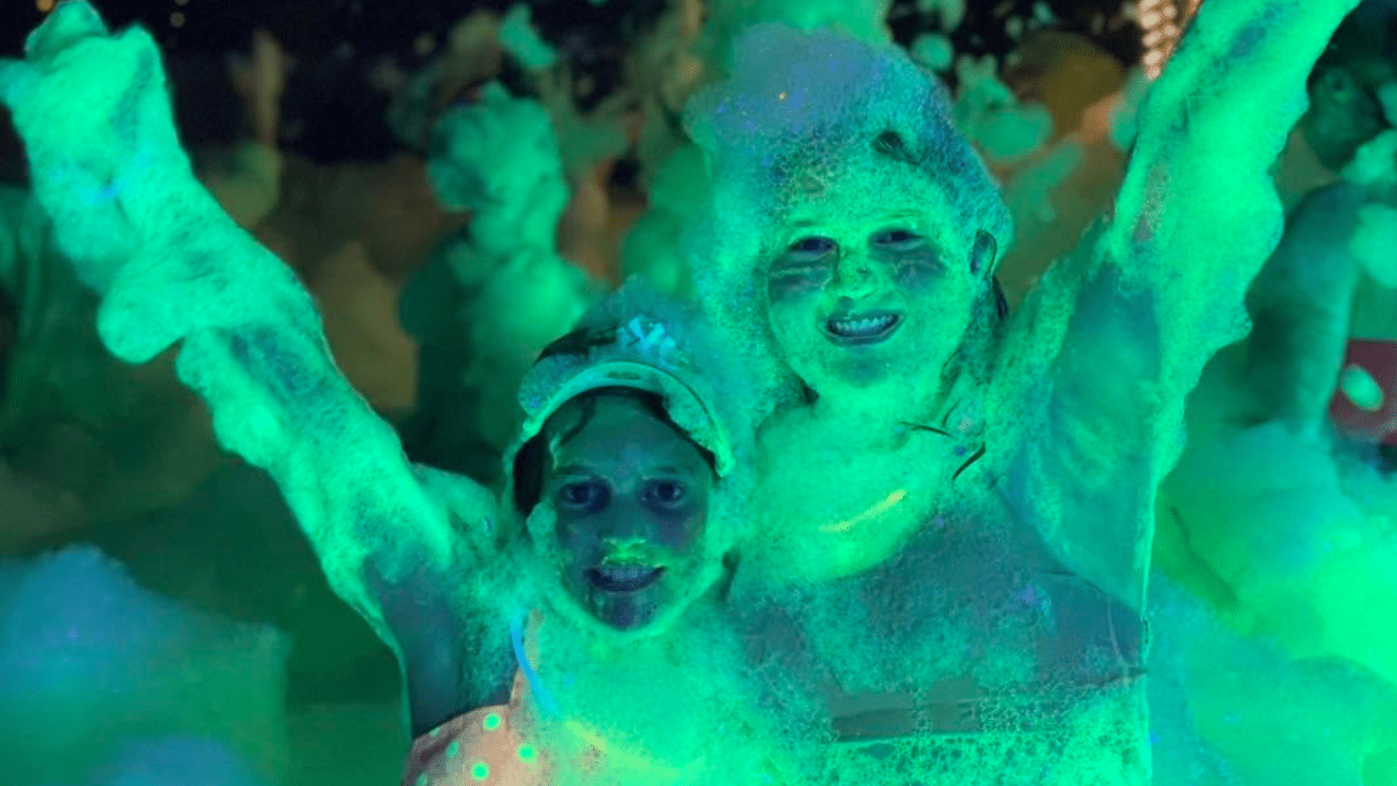 Happy children playing in a foam filled backyard