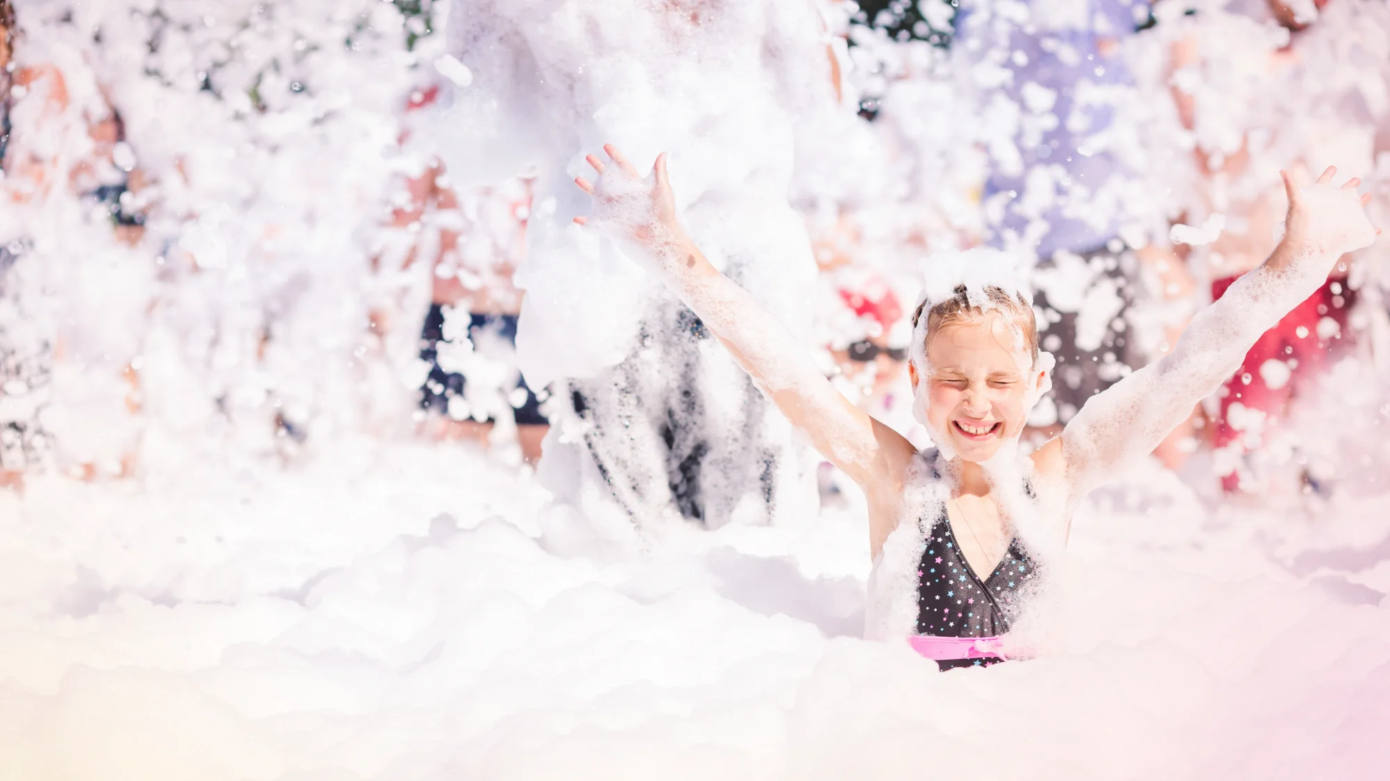 A lively Foam Party with guests enjoying the foam fun.